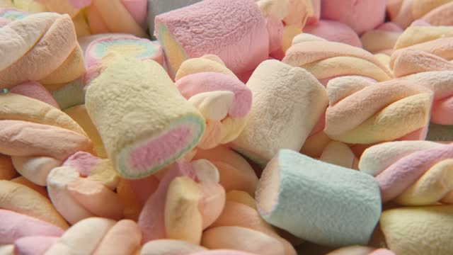 Colorful marshmallow spinning, rotation. Sweet food background. Close up. Video backdrop. Heap of multi-colored candies with different flavours. Group of tasty marshmallows. Confectionery. Sweet shop