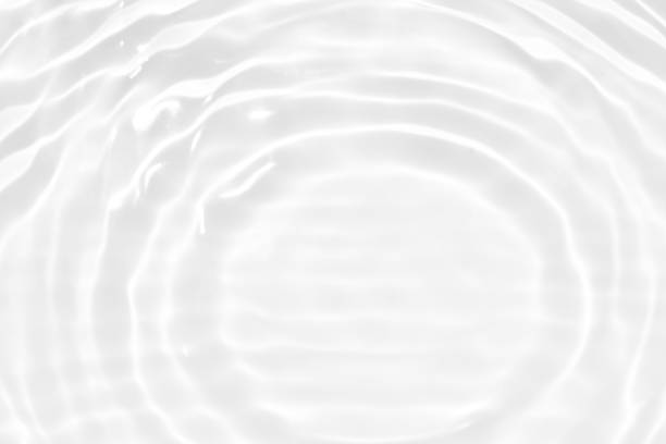 istock Defocus blurred transparent white colored clear calm water surface texture with splashes and bubbles. Trendy abstract nature background. Water waves in sunlight with copy space. White water shine 1475513181