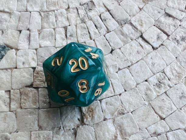 istock D20 green role playing dice on mosaic table 1475515911