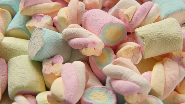 Colorful marshmallow spinning, rotation. Sweet food background. Close up. Video backdrop. Heap of multi-colored candies with different flavours. Group of tasty marshmallows. Confectionery. Sweet shop
