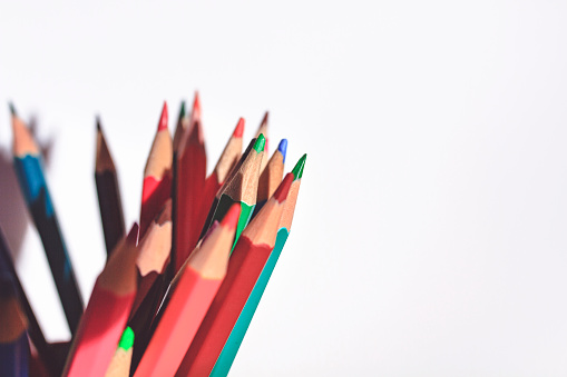 Back to school concept with colored pencils on white background. Close up. Art and craft. Design professional. Education. Office supplies. Copy space.