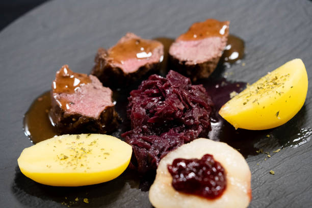 Saddle of venison Rehrücken mit Rotkohl und Salzkartoffeln cow moose stock pictures, royalty-free photos & images