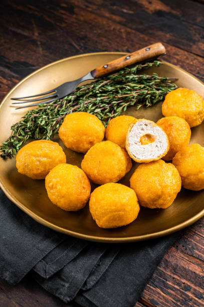 istock Fried crispy round chicken nuggets with Cheese. Wooden background. Top view 1475519626