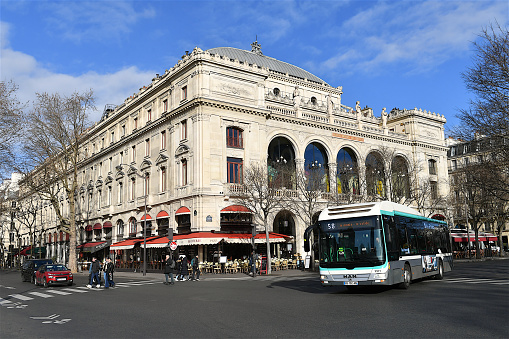 Paris, France-02 25 2023: People and a bus in front of the Théâtre du Châtelet, which is a theatre and opera house, located in the place du Châtelet in the 1st arrondissement of Paris, France.