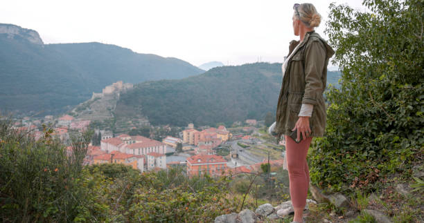 istock Mature woman walks along narrow path in hilly setting 1475521846