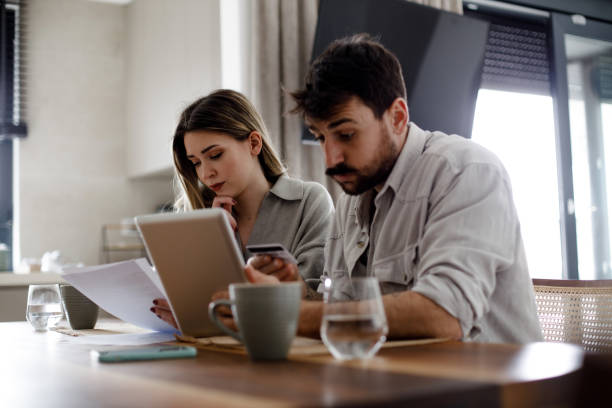 istock Serious couple analyzing budget or utility bills at home 1475522197