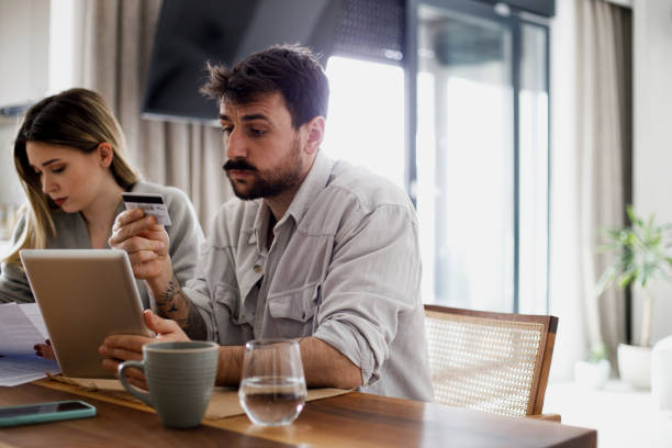 istock Serious couple analyzing budget or utility bills at home 1475522201