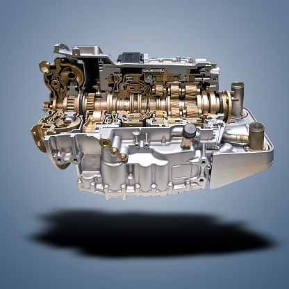 Floating  Modern car engine and gear box on blue gradient background
