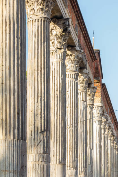 Rhythm of ancient columns against a blue sky on a sunny day in Milan. High quality photo