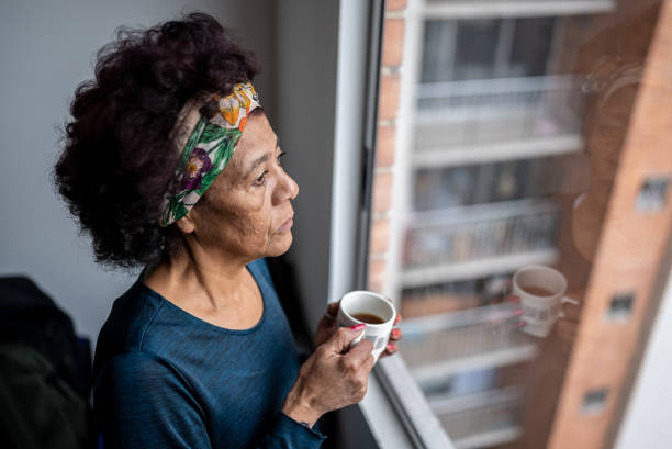 istock Senior woman contemplating while drink a coffee cup at home 1475529768