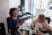 istock Senior friends talking in the dining table on a coffee time at home 1475529897