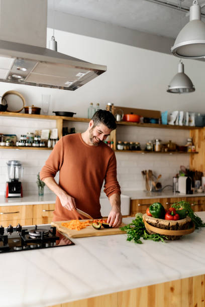 Man preparing food in kitchen.