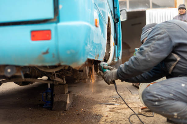 istock A mechanic uses an electric grinder to remove a rusted part from a vehicle. 1475530752