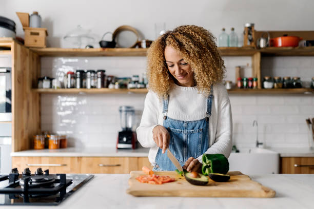 istock Woman preparing food in kitchen. 1475532633