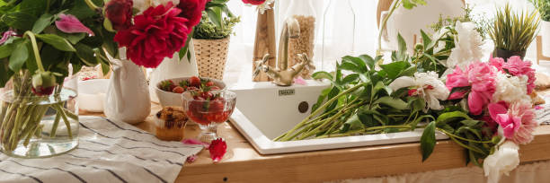 istock The kitchen countertop is decorated with peonies. The interior is decorated with spring flowers 1475538464