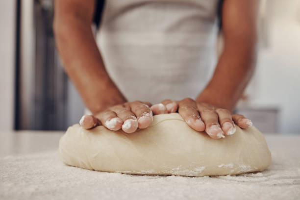 istock Chef hands and dough press for baking preparation work, production and process of man at culinary counter. Restaurant worker in professional kitchen preparing bread, cake or pizza recipe. 1475540642