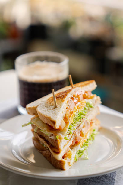 istock Healthy sandwich with fried egg, tomato and cabbage. Breakfast table with sandwich and coffee. 1475542475