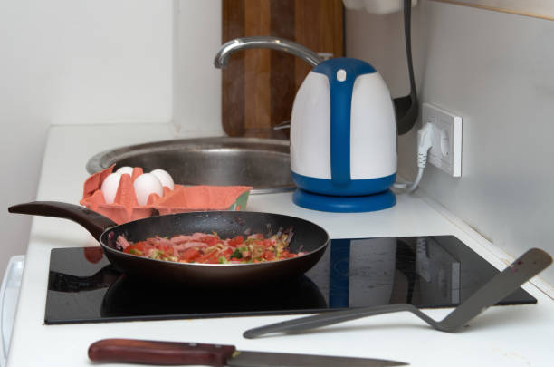 istock Cooking scrambled eggs with ham. Frying onions and vegetables in a pan 1475544367