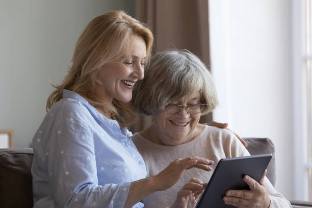istock Mature woman helps to elderly mom with digital tablet usage 1475545114