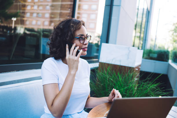 istock Cheerful executive talking on phone in outdoor cafe 1475545532
