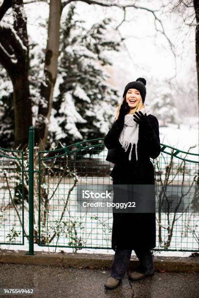 Young Woman With Warm Clothes In Cold Winter Snow Drinking Coffee To Go  Stock Photo - Download Image Now - iStock