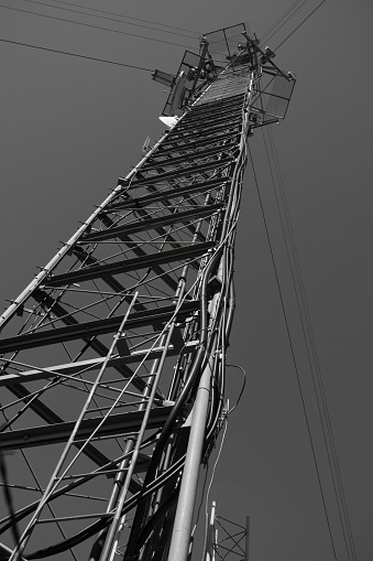 Radio, television broadcast or Cell cellular signal tower from underneath looking straight up into sky, horizontal frame