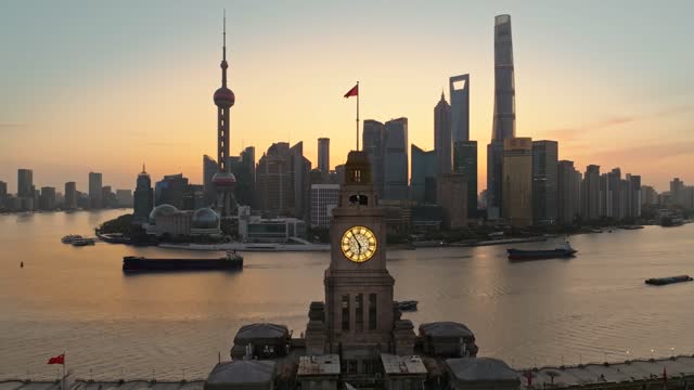 Aerial footage of The Bund and Lujiazui in Shanghai China at sunrise.The old customs house as a foreground.