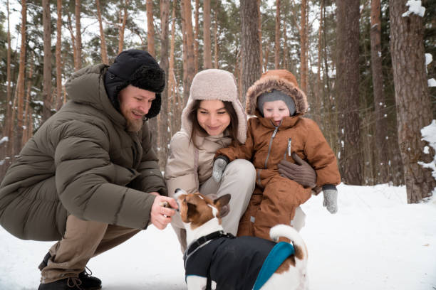 istock parents with son walking in forest  with dog 1475551898