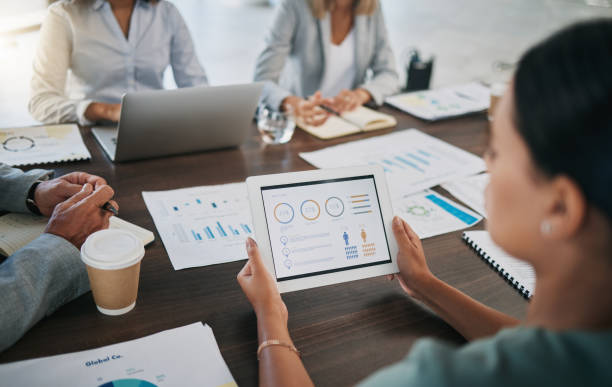 istock Digital tablet, meeting and business people with paperwork planning a project with data, graphs and statistics. Technology, documents and team working on a corporate company strategy in the workplace 1475551954