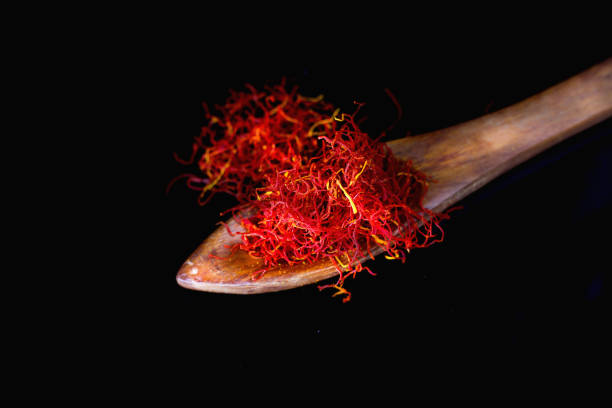 Saffron in Wooden Spoon With Black  Background stock photo