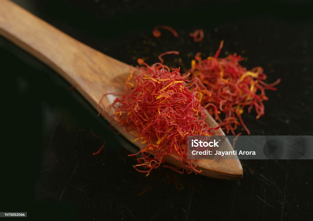 Saffron in Wooden Spoon high Angle Close-up Stock Photo