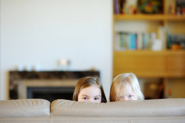 istock Two little sisters having fun at home 1475553538