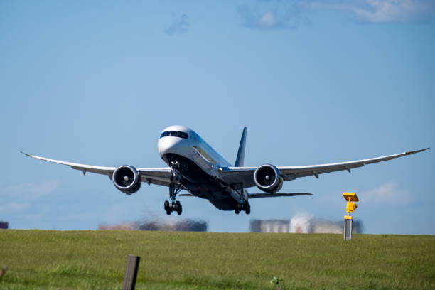 air canada commercial airplane taking off from runway and climbing with engine exhaust stock photo. - boeing 787 air vehicle travel business travel imagens e fotografias de stock