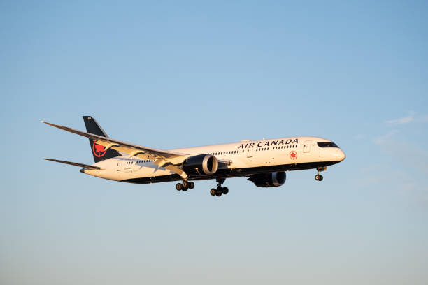 air canada commercial airplane on final approach to land during sunset stock photo. - boeing 787 air vehicle travel business travel imagens e fotografias de stock