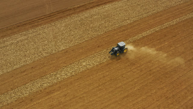 AERIAL Tractor prepares the soil for sowing in the spring season. The beginning of the agricultural spring