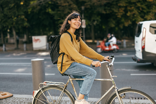 Young woman biking in a city - stock photo