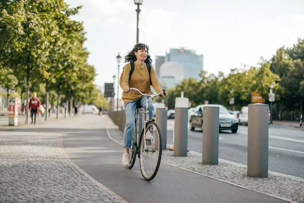 A Woman Rides a Bike through the Streets