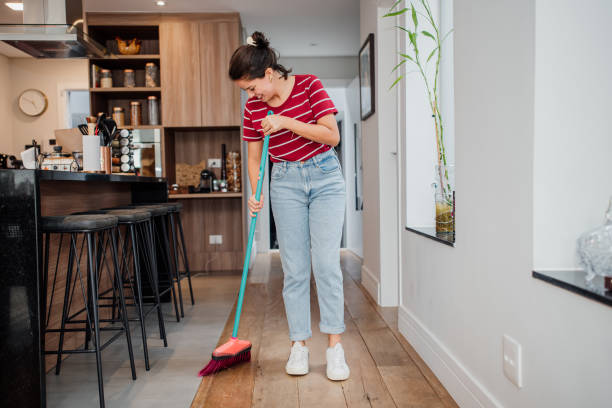 mujer barriendo el piso de la casa - barrer fotografías e imágenes de stock