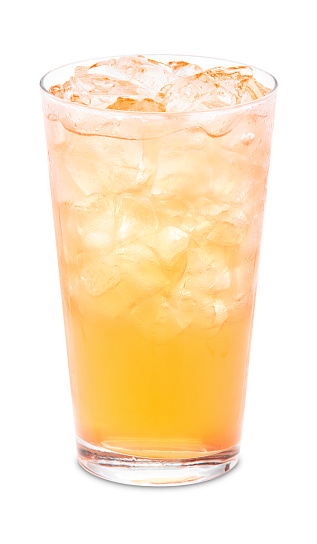 Glass of orange soda with ice cubes and straw isolated on white background