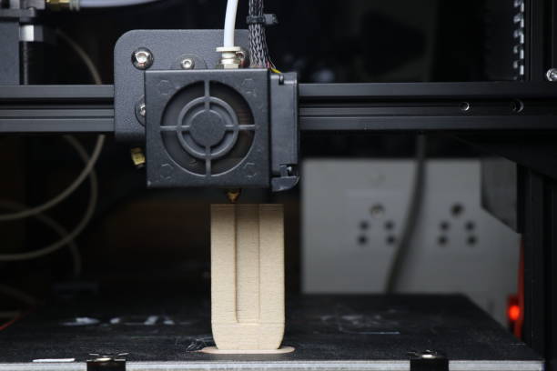 istock The 3D printing machine making the 3D prototype model by using wooden PLA filament material 1475561878