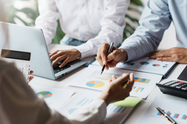 istock Business people point to graph and chart to analyze market data, balance sheet, account, net profit to plan new sale strategies to expand productivity. 1475564367