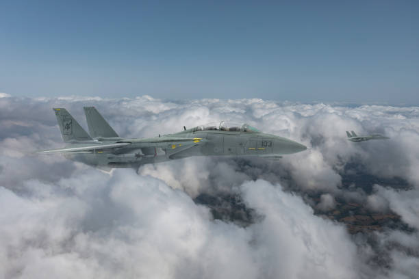 istock Jet aircrafts flying over the clouds. 1475565061