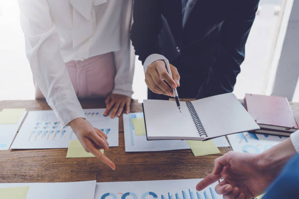istock Group of businessmen explaining the concept marketing strategy analyze graphs and charts on corporate growth at company meeting. 1475565186