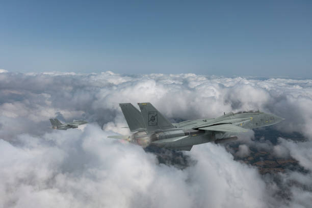 istock Jet aircrafts flying over the clouds. 1475565739