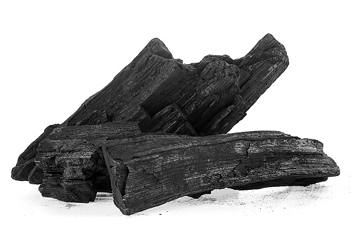 Pile of natural wood charcoal isolated on a white background. Hard wood charcoal.