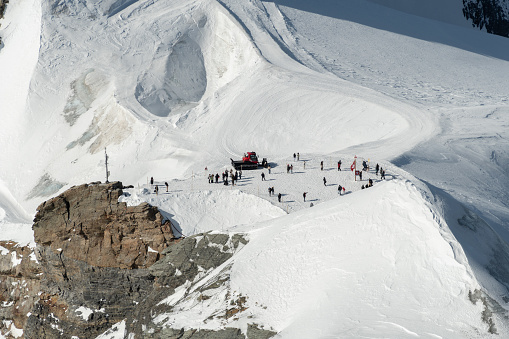 Jungfraujoch, Canton Bern, Switzerland, February 11, 2023 People standing on the top platform on a sunny winter day