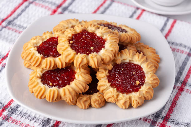 istock cookies with raspberry jam on a white plate and a checkered napkin, on the table 1475570413