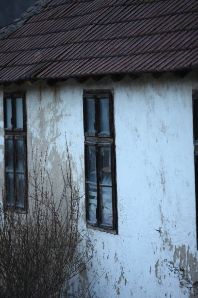 istock Old wooden windows on a dilapidated old house 1475572849