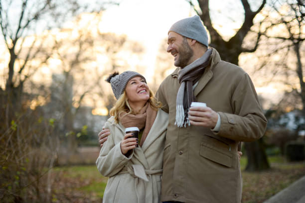 istock A happy romantic couple with coffee walking in the park 1475574657