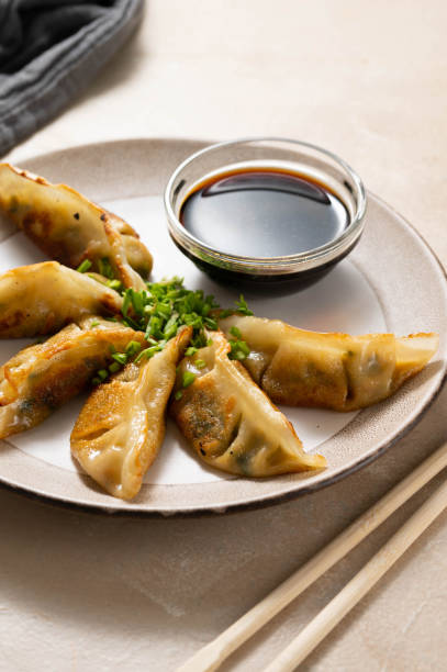 istock Fried dumplings gyoza with soy sauce, and chopsticks. 1475580648